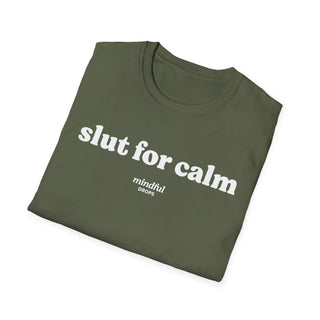 Folded green t-shirt with 'slut for calm' text on a white background