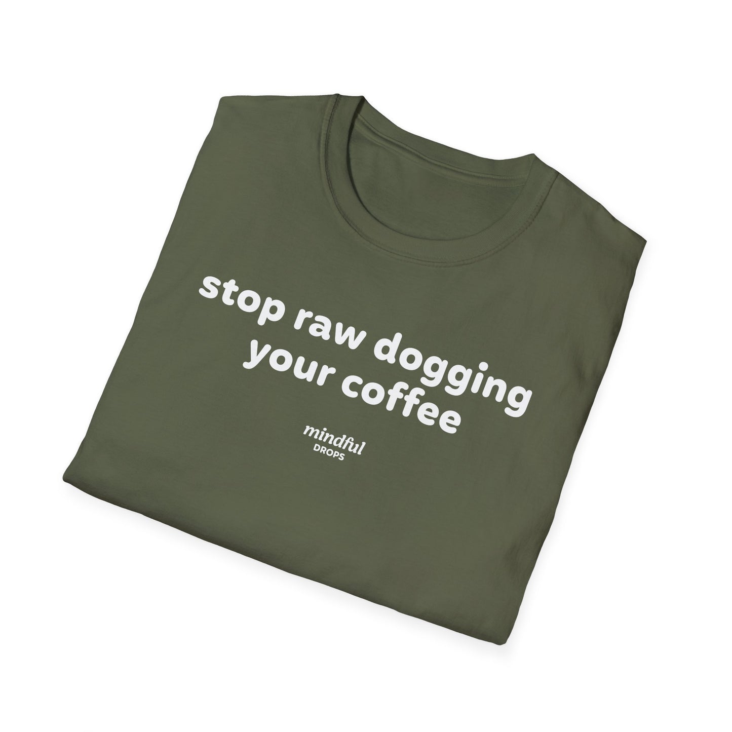 Folded green t-shirt with white text 'stop raw dogging your coffee' on a white background
