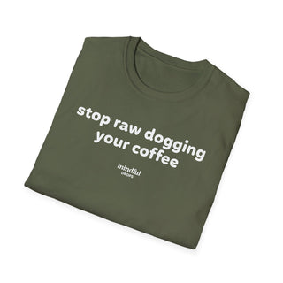 Folded green t-shirt with white text 'stop raw dogging your coffee' on a white background