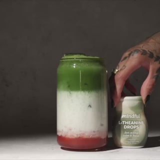 Hand adding Mindful Drops liquid L-theanine to coffee, matcha, sparkling water, and other beverages, demonstrating how the flavor-neutral supplement can be used in everyday drinks. 